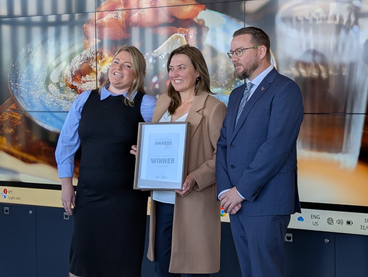 Three people accept award.