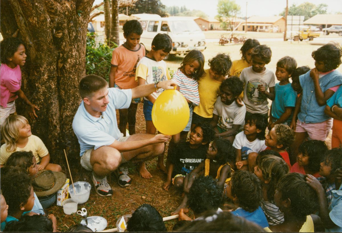Kids watch a man doing a science experiement