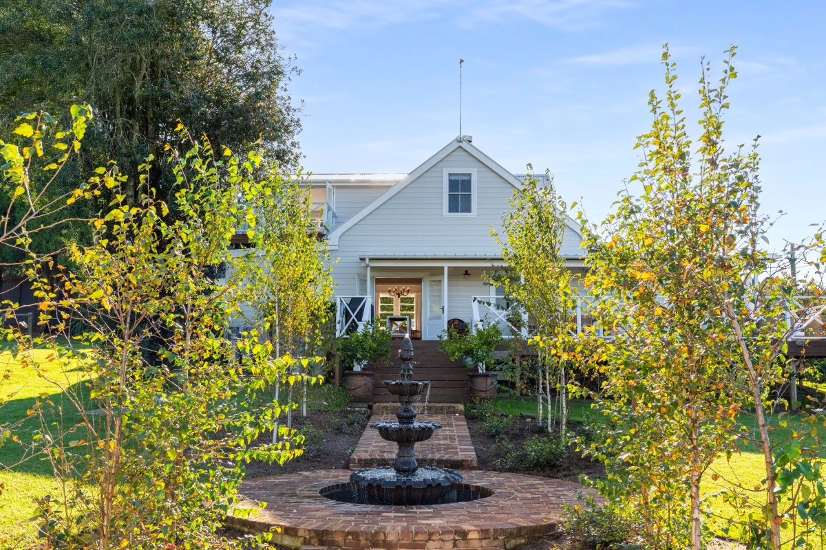 homestead gardens with water fountain and brick pathways