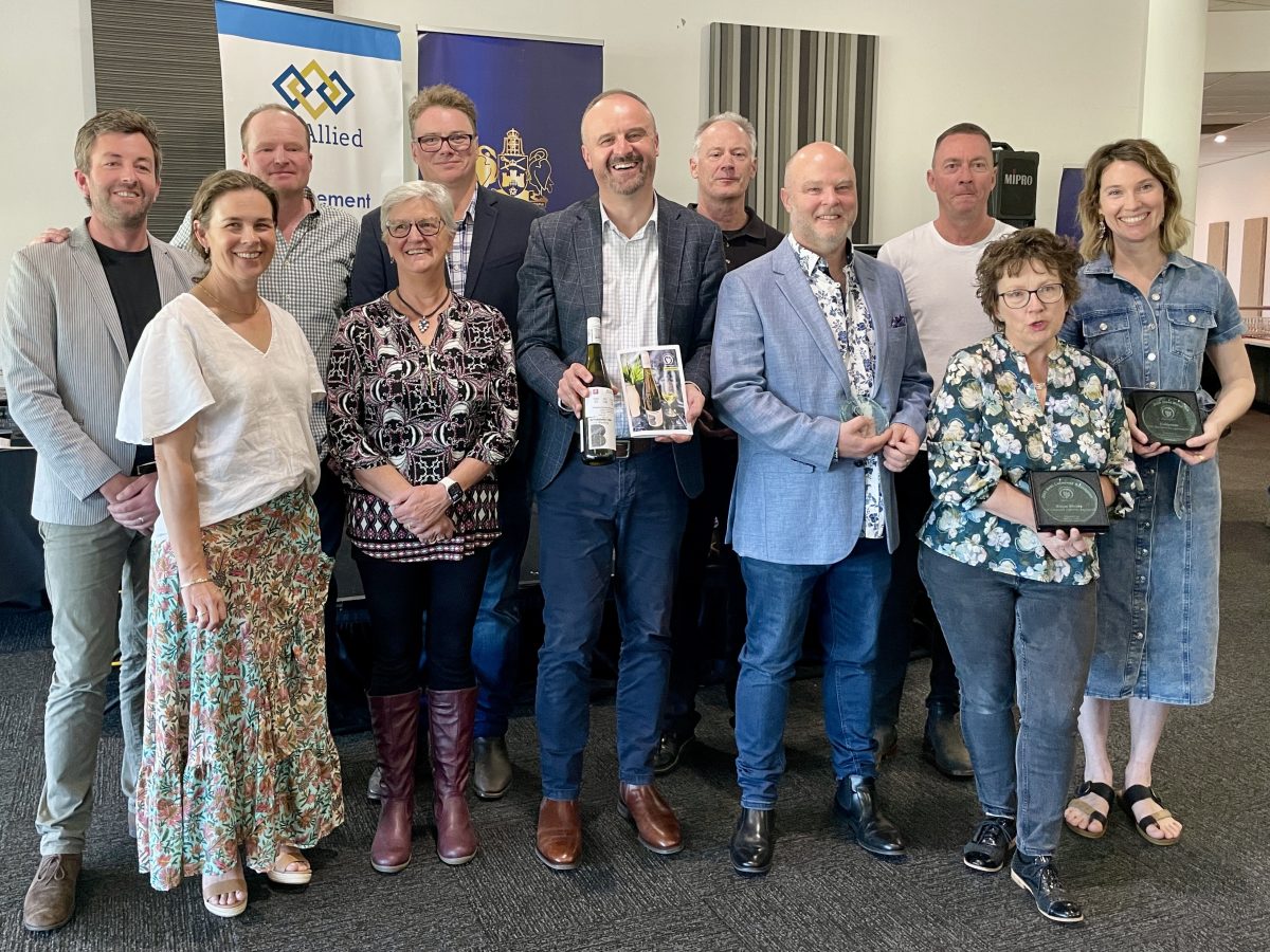 A group of people holding awards.