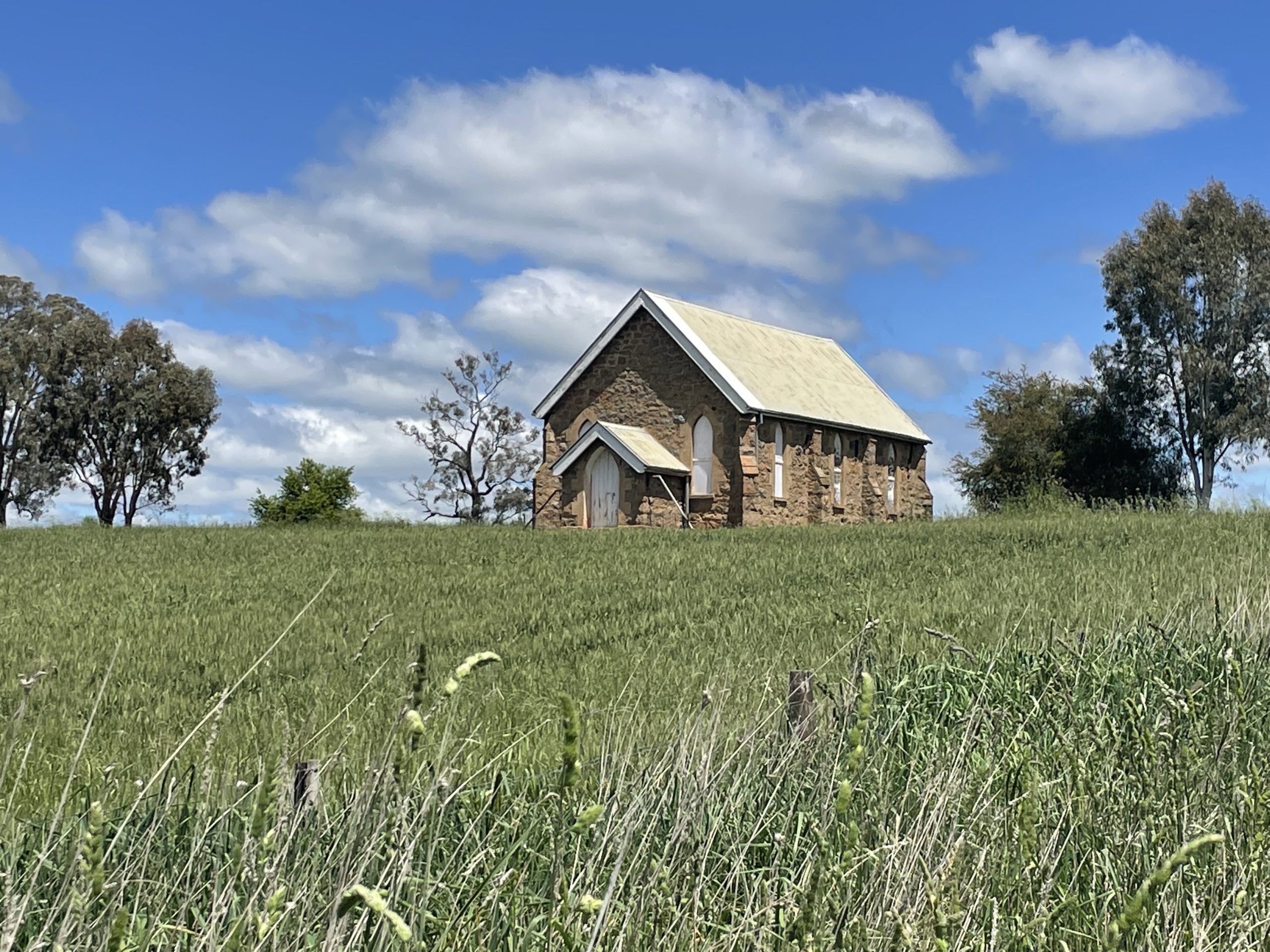 small stone church in paddock