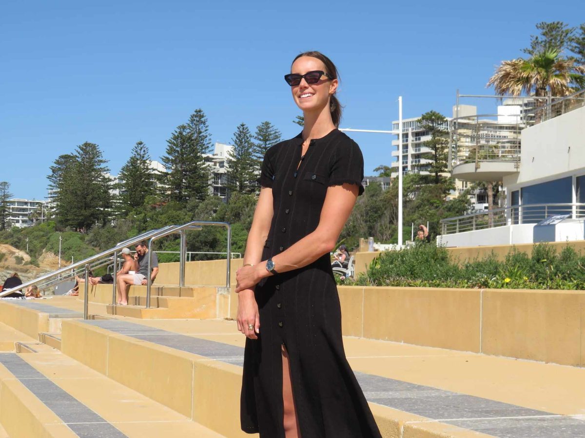 a woman standing at a beach promenade