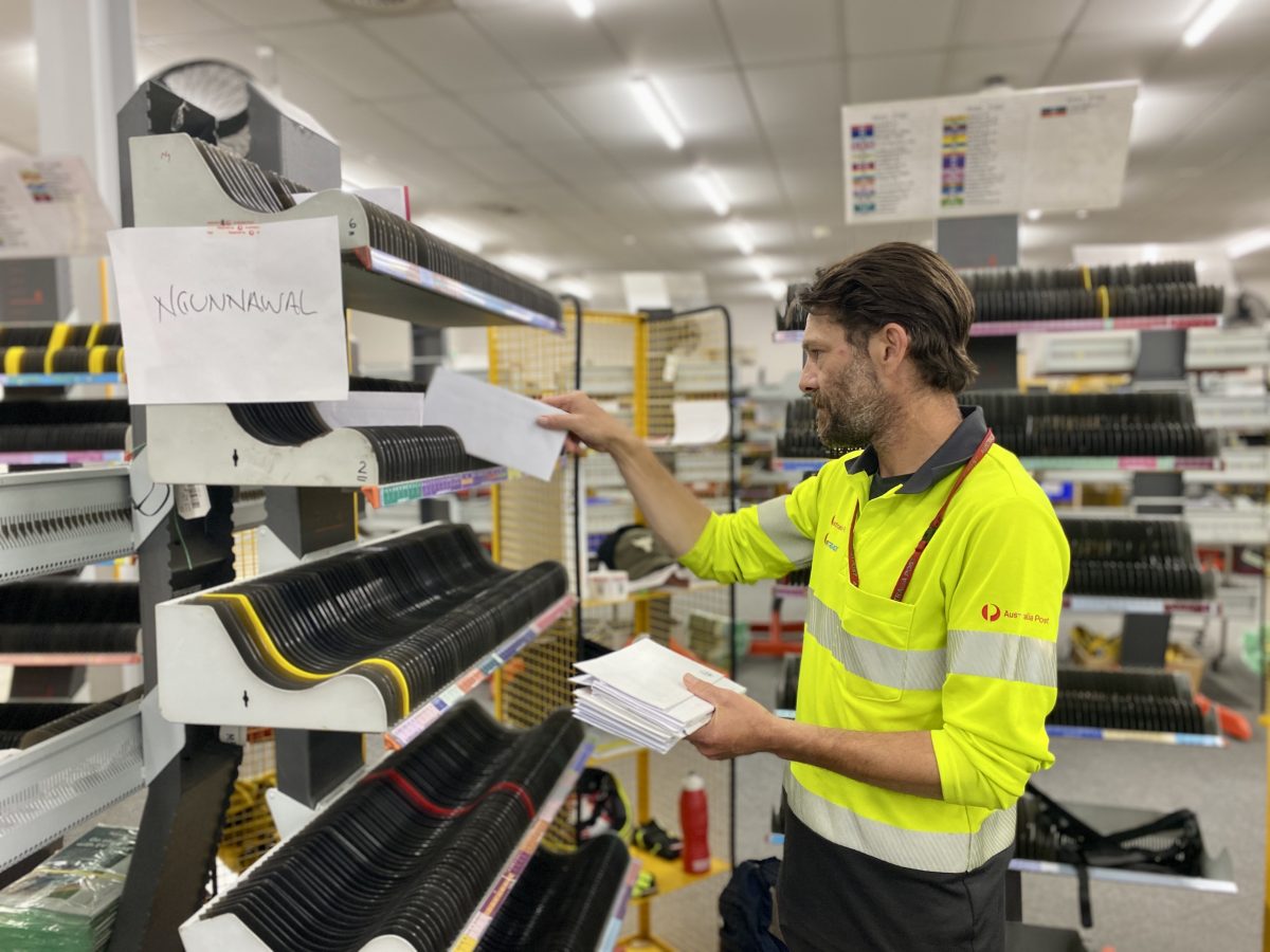 Australia Post worker sorting mail