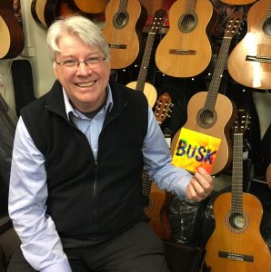 Allan Spencer, founder of the Australian National Busking Championships, with the Busk CD featuring talent from the festival.