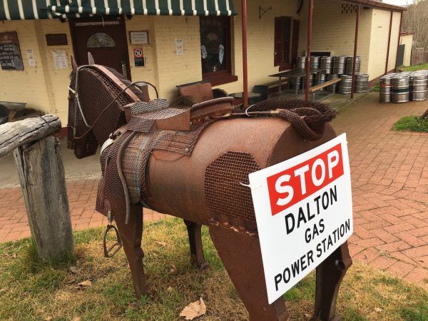 protest sign on a fake horse