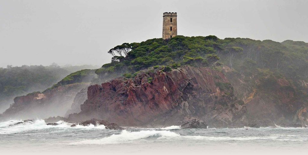 View of cliffs, surf and Boyd's Tower in Ben Boyd National Park.
