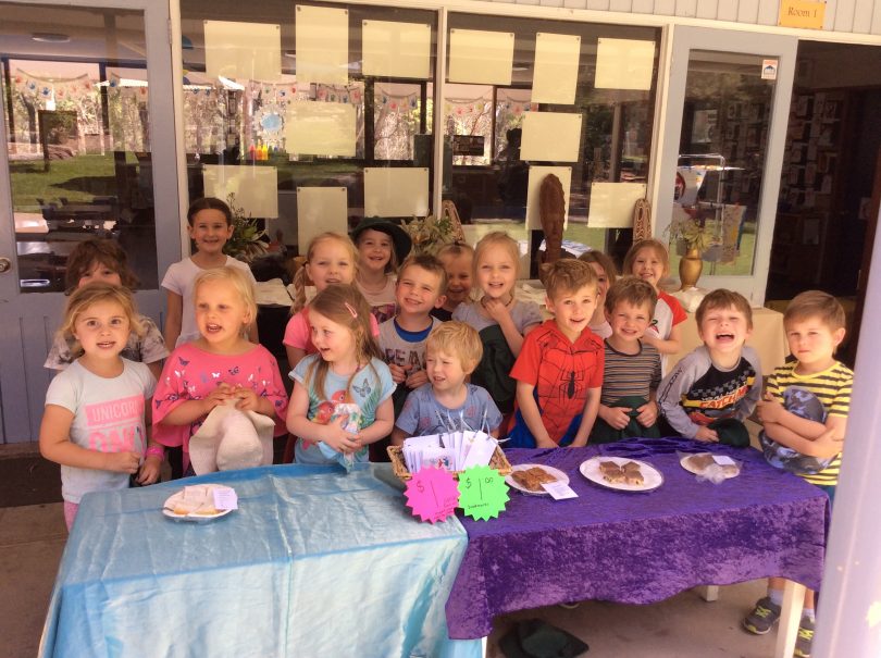 The kids of Pambula Preschool an their 2018 PNG cake stall. Photo: Supplied.