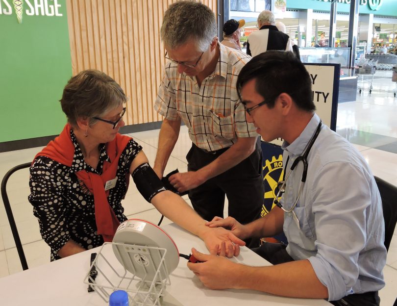 Dr Andy Piotrowski (centre) supervises community blood pressure screening. Photo: Supplied.