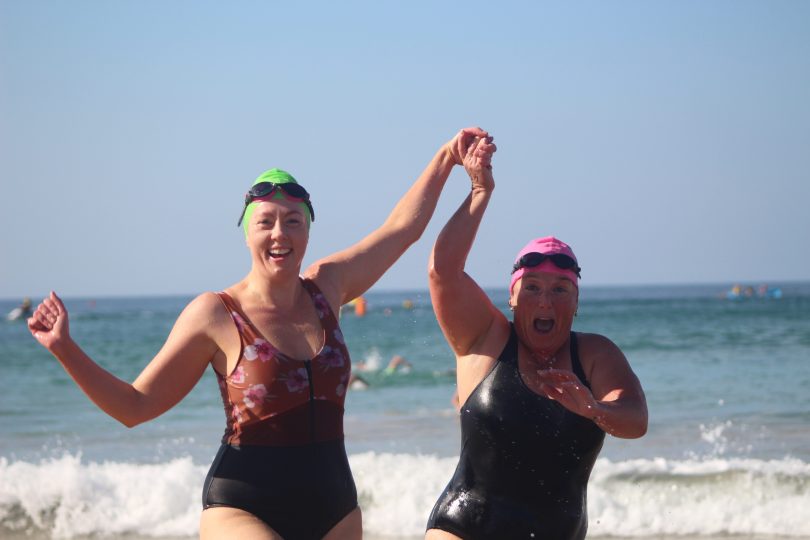 Kathryn Whiting and Melissa Hazell finishing together, after training for months at Moruya pool. Photo: Alex Rea