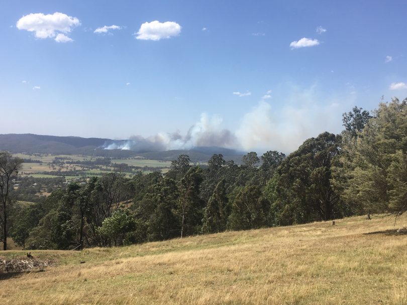 The early stages of the March 18, 2018 bushfire that destroyed 65 homes, as seen from Black Range. Photo: Ian Campbell.