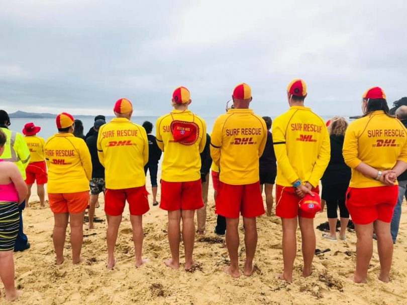 30 members of Bermagui SLSC as well as Marine Rescue Bermagui paused at 12:30 pm yesterday for a minute of silence in honour of their fellow lifesavers. Photo: Bermagui SLSC Facbook.