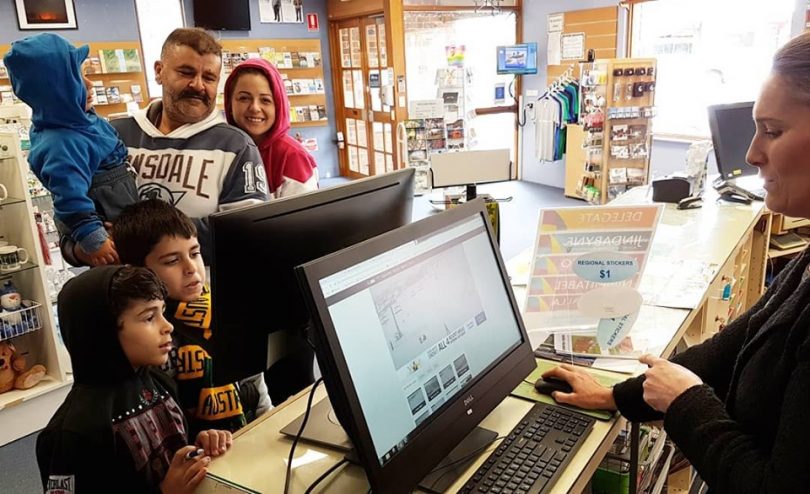 A family from Parramatta making their first trip to the snow, startng with advice from the Cooma Visitors Centre. Photo: Cooma Visitors Centres Facebook.