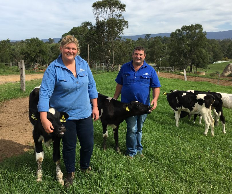 Ashleigh and X Rood with poddy calves on their dairy farm. Photo: Supplied.