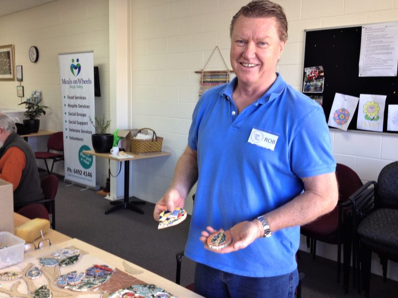 Rob Bowerman of The Gypsy Soul Studio shows off some mosaic leaves made at the Bega Meals on Wheels social group. Photo: Elka Wood.