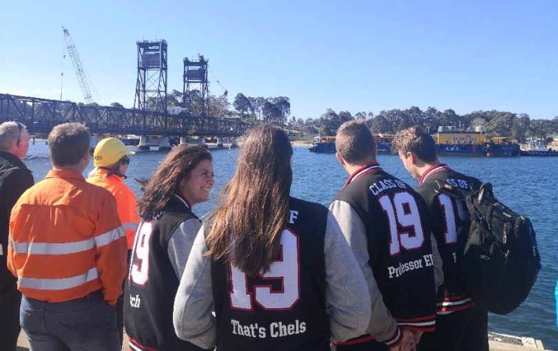 Batemans Bay High School students were among the crowd who welcomed a second massive construction barge to the Clyde River. Photo: Supplied.