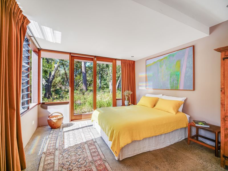 One of the light-filled bedrooms with sweeping bush views. Photo: Supplied. 
