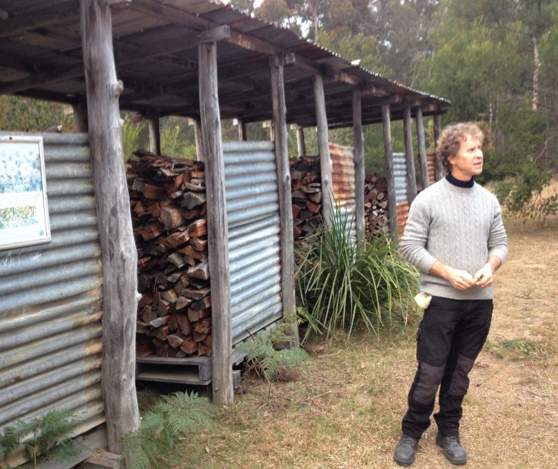 Dean Turner in front of The Crossing's 'wood bank,' which has bays of wood up to six years old. Photo: Elka Wood. 