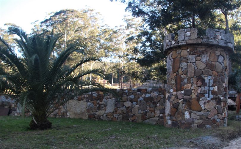 Stone gateway and palm tree