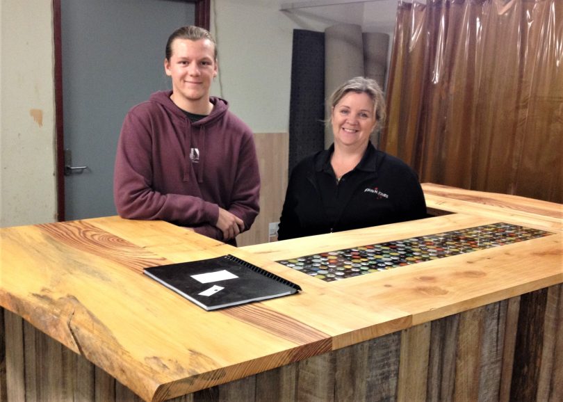 Year 12 student Billy Stubbs with his proud mum Kelly Cody behind the bar he built for HSC woodworking. Photo: Elka Wood. 