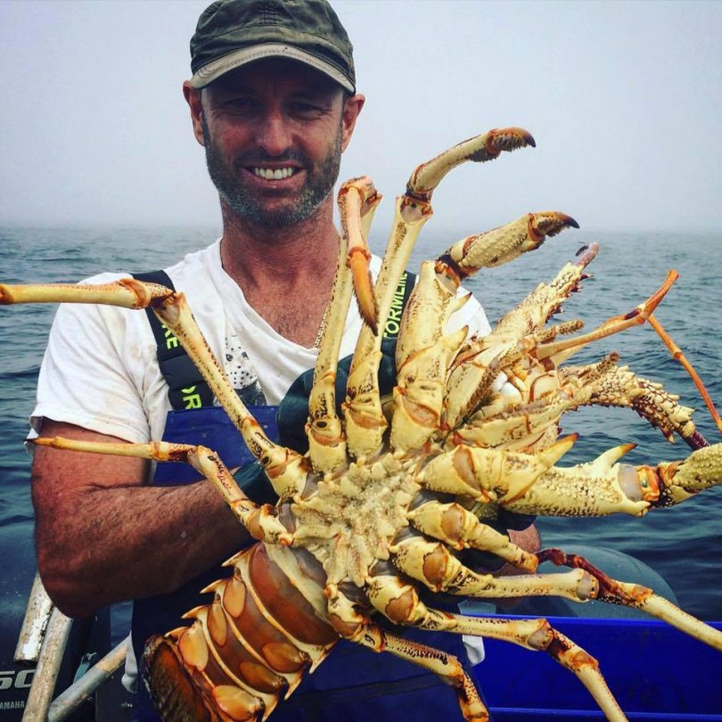 Jason Moyce traps lobsters over the summer period and is seen here with the catch of the day. Photo: Supplied. 