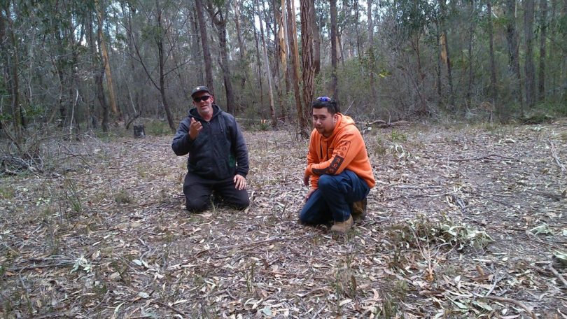 Bega Local Aboriginal Land Council team members Kelvin Howarth and Peter Dixon service a fox control site on Aboriginal land at Wallagoot. Photo: Supplied.