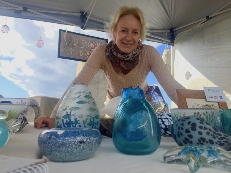 Mia Karlsson with her hand-blown wares greet the Pacific Explorer. Photo: Lisa Herbert