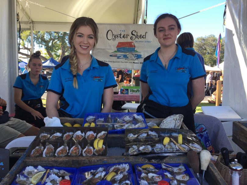 Two girls working at a stall at the 2019 Narooma Oyster Festival.