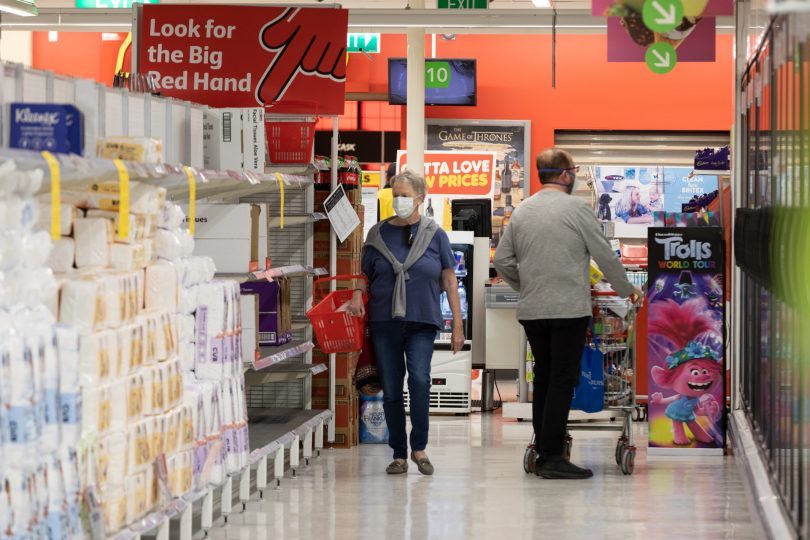 Shoppers wearing masks at a Coles supermarket last week. 