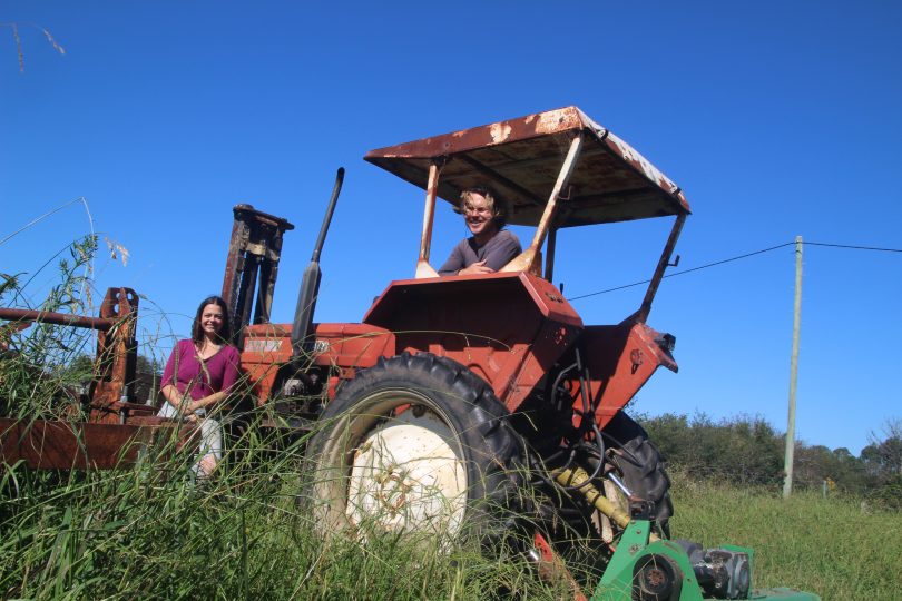 Eliza Cannon and Alex Chiswell on a tractor on their farm.