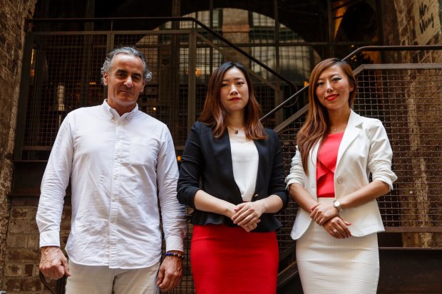 The Atlas Advisors executive team (from left): Guy Hedley, Fiona Zhuang and Jade Bao standing in front of brick building..