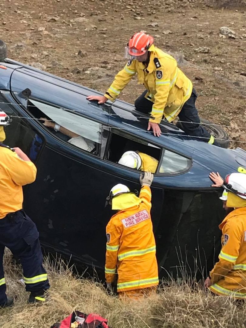 A Rural Fire Service crew assisting at the scene of a motor vehicle accident south of Cooma.