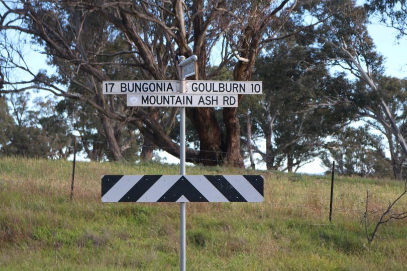 Street signs on rural Mountain Ash Road.