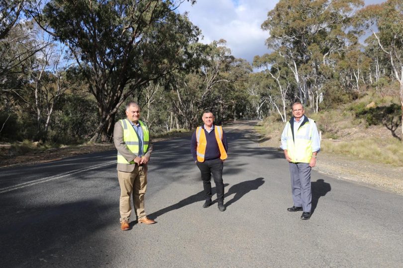 Trevor Hicks (left), John Barilaro (centre) and Tim Overall (right) standing on Captains Flat Road.
