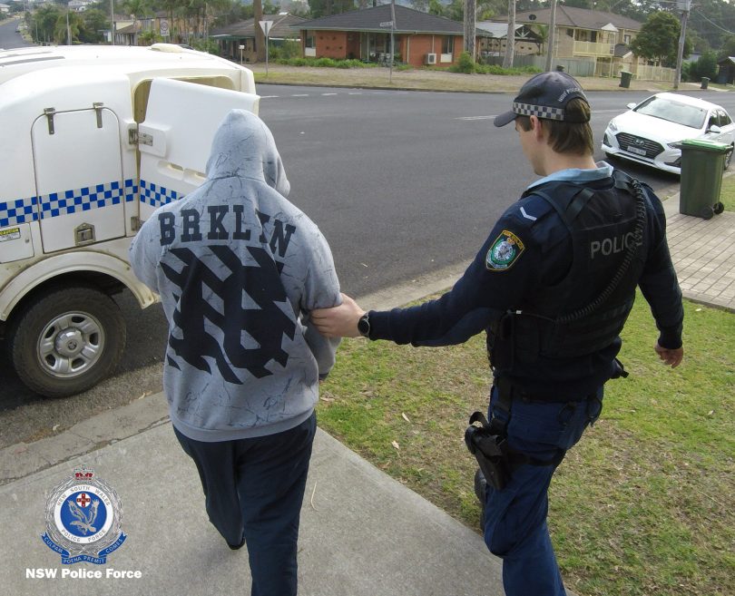 A suspect being arrested by NSW Police at Surf Beach.