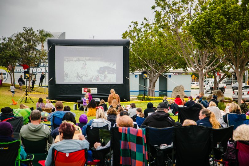Crowd watching film at outdoor cinema on Batemans Bay waterfront.