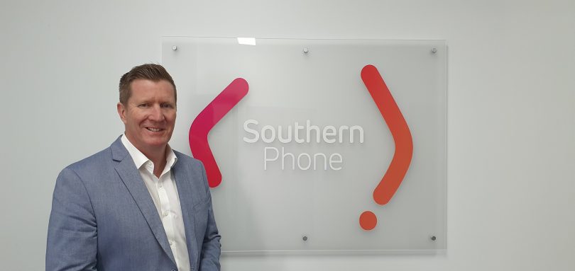 Southern Phone CEO David Joss standing in front of company sign.