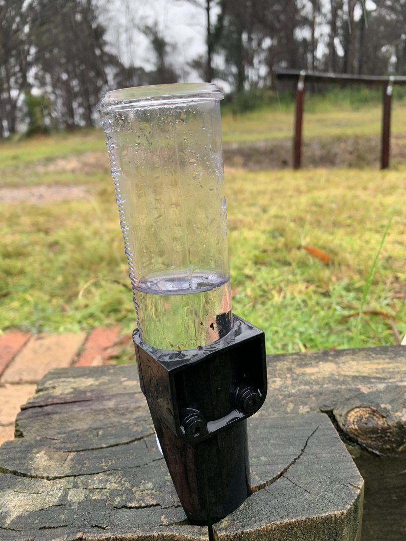 Semi-full rain gauge on rural property.