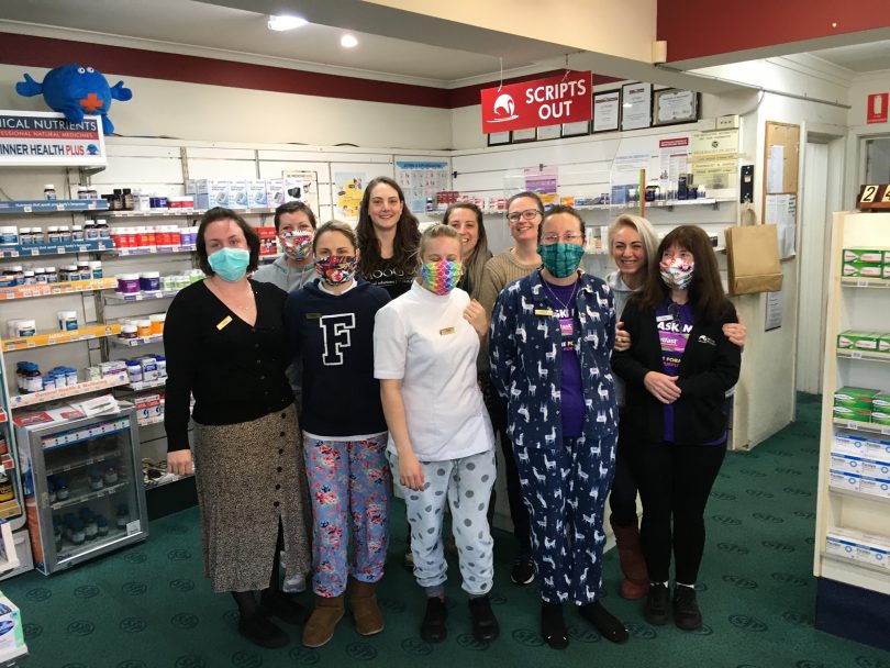 Staff at Moruya Pharmacy standing in store wearing fabric face masks.