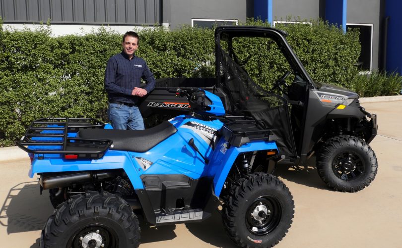 Alan Collins standing with quad bike and Polaris.