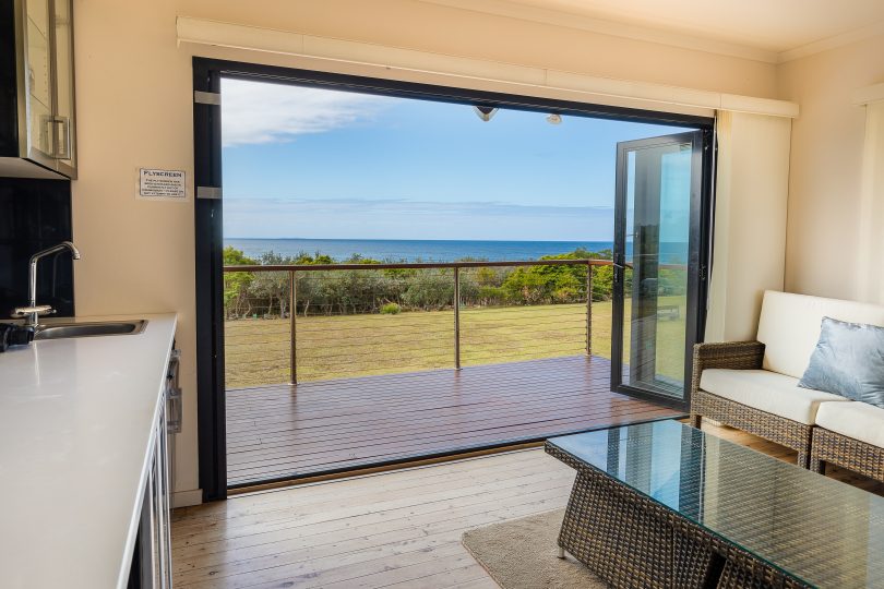 Sea view through open doors at 25 Keating Drive, Bermagui.