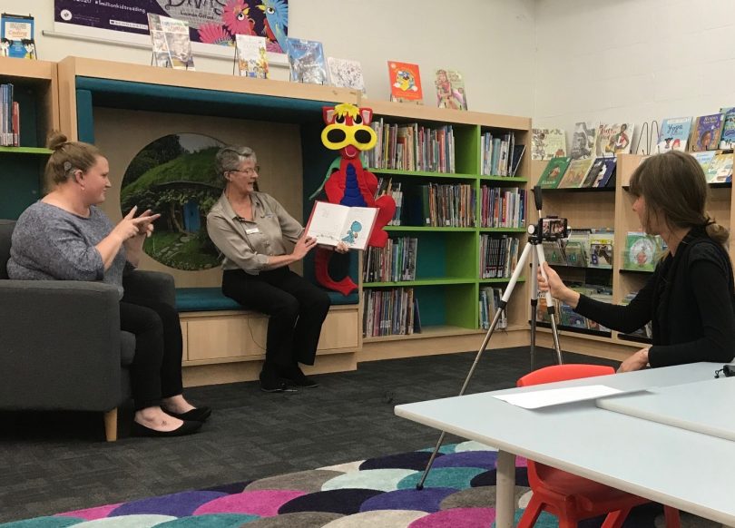 Stephanie Johnston (left) and Anne Moore (centre) delivering storytime in Auslan at Bega Valley Shire Library.