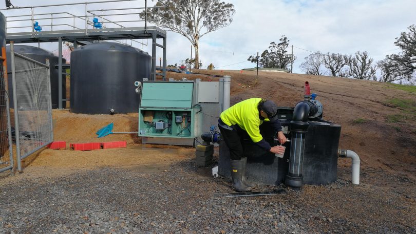 Council worker Paul Lazarro taking water at temporary water settling plant at Upper Brogo.