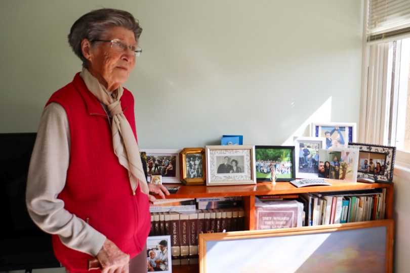 Gwen O'Brien at home in front of photos of her late husband Geoffrey O'Brien.