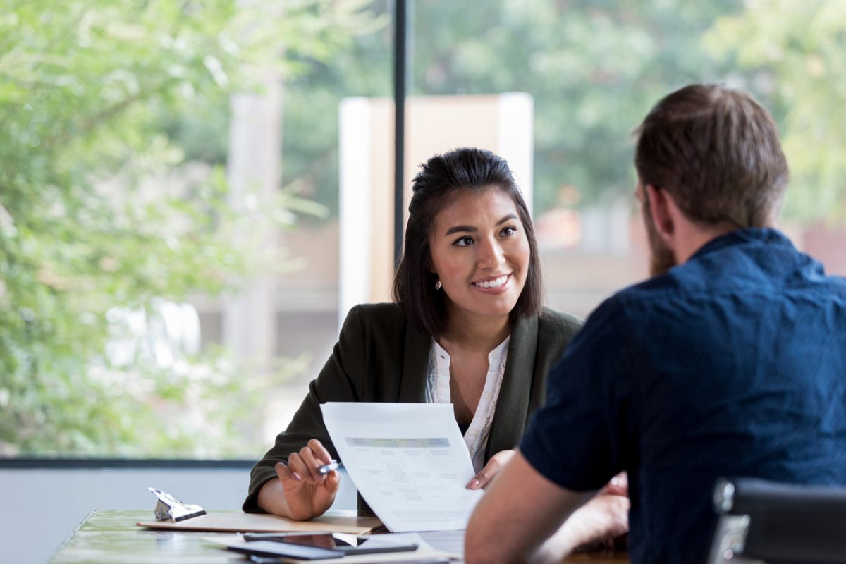 A woman smiling at a man in an office