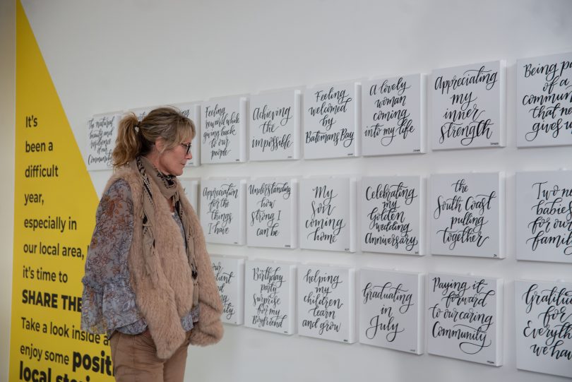 Eurobodalla Mayor Liz Innes reading the wall of positive quotes at Village Centre in Batemans Bay.