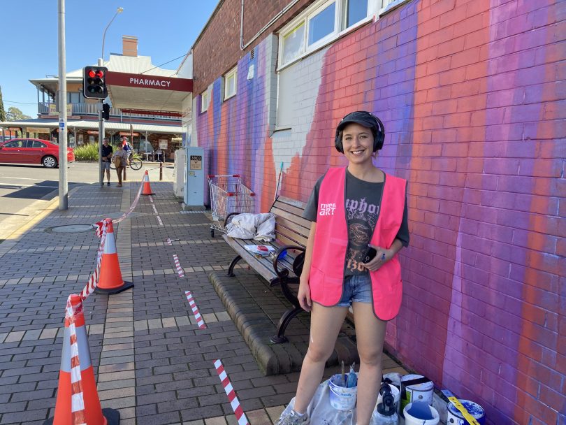Artist Claire Foxton at mural site in Moruya.