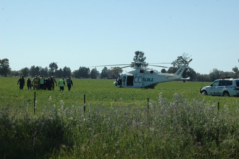 Emergency services workers preparing to airlift woman near Young.