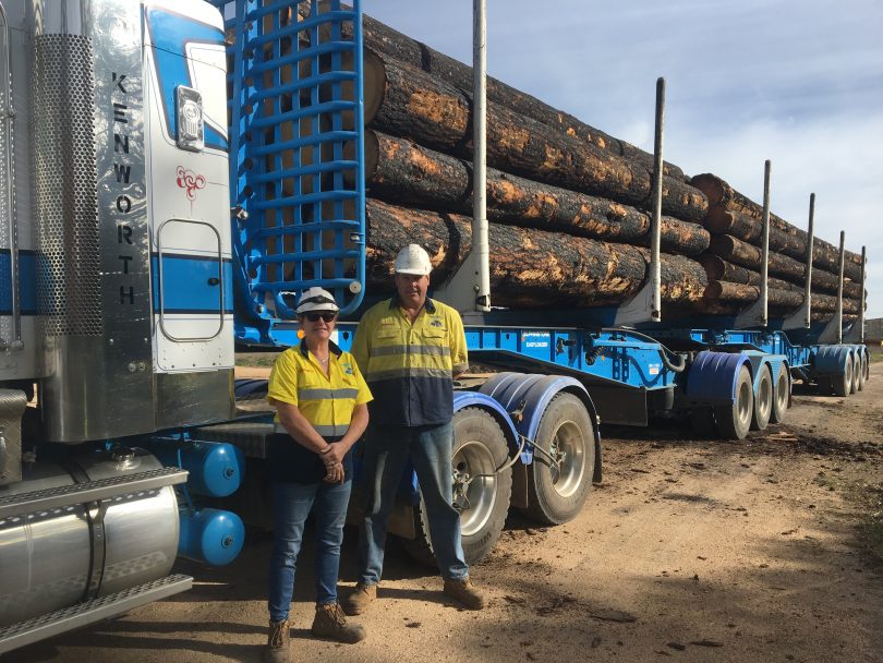 Cheryl Hawkins and Grant Cobden from Bergin's Logging standing in front of logs on truck.