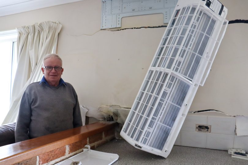 Colin Picker standing in kitchen damaged by lightning.
