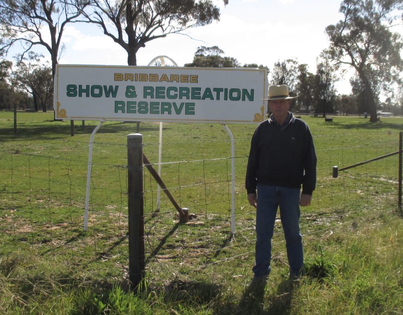 Bill West standing in front of Bribbaree Show & Recreation Reserve sign.